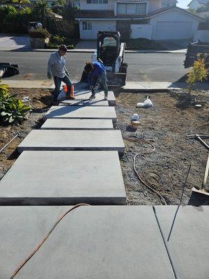 Squares cut out of a driveway-