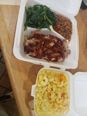 Pulled pork,  collard greens,  baked beans,  and mac&cheese