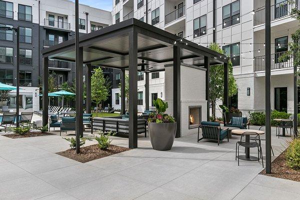 Relax in the outdoor living room with fireplace and TVs