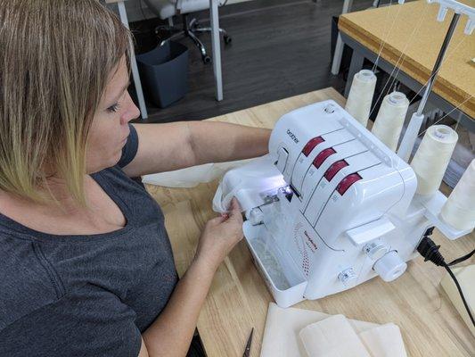 A student working on an overlock machine - making ruffles!