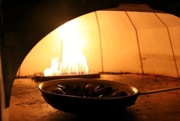 Mussels Roasting roasting in brick oven at ROW