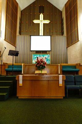 The table and the stage. Multicultural communion is served monthly.