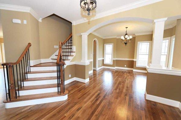 Elegant living room and staircase leading to the upstairs. We painted all walls and trim for this job.