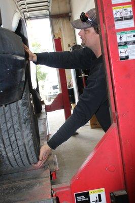 Eddie our Oil & Lube Tech- Checking to see if there is any front end loose play.