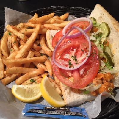 Shrimp Po'boy dressed with some crazy sauce and perfectly seasoned french fries.