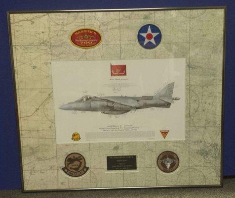 I did this for a local military squadron. It is a map mounted to a mat board with cut outs for the picture and patches.