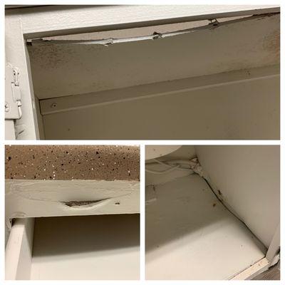 Water damage below sink, sunken in roof of cabinet, peeling (new) paint.