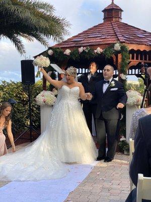 Bouquet, garland, and pillars with centerpieces.