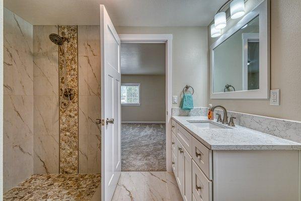 Wonderfully remodeled master bath. With new vanity and quartz countertop. Calacatta tile floor to match shower surround.