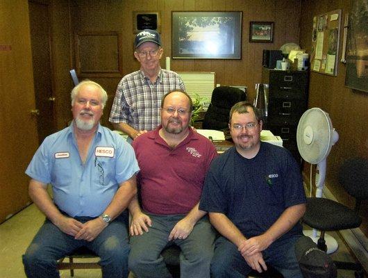 THE ANCHOR (Founder)  Garnett George, 1927 - 2017 Jonathan (Technician), Arnold (President), and Ed (Vice President). Photo taken 2010.