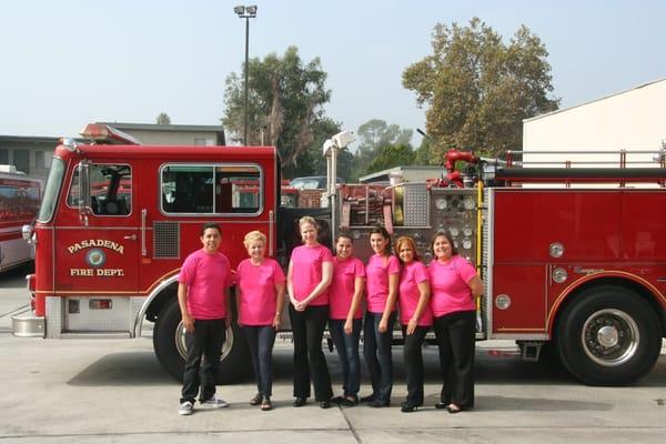 Some of the Pasadena office supporting breast cancer with the Pasadena Fire Department