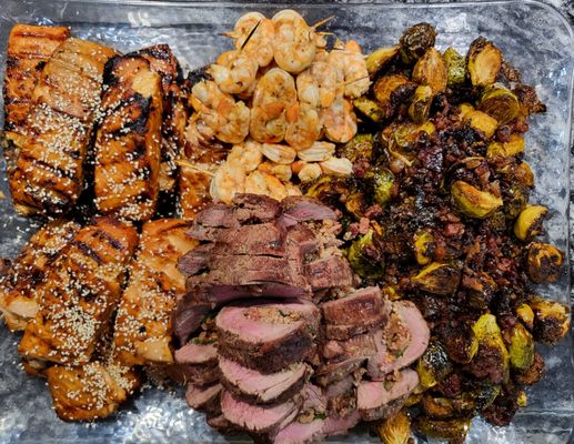 Class dinner.  Asian salmon, beef loin stuffed with bacon and spinach, mojo shrimp, balsamic glazed Brussels sprouts with chopped bacon