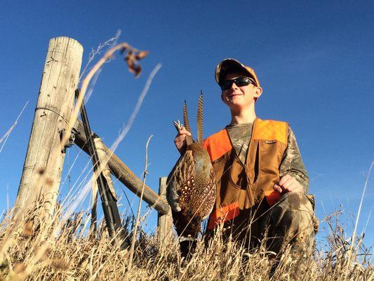 Zach with his first South Dakota pheasant with the help of HuntFishSD.com.