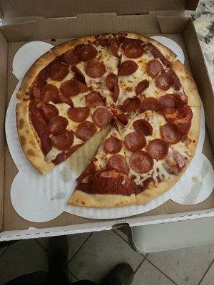 A pizza that is missing a slice and has way too much sauce