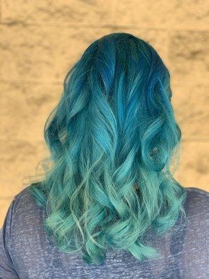 Women's fashion color mermaid inspired hair color with haircut and beach waves