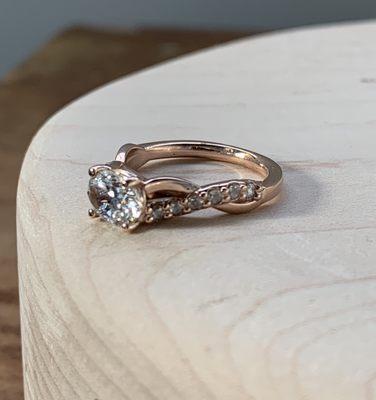 Custom oval diamond "entwined" solitaire set in 14k rose gold.  Fine, handmade wedding jewelry.