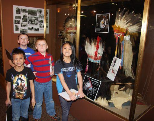 School group looking at one of the Native American Exhibits.