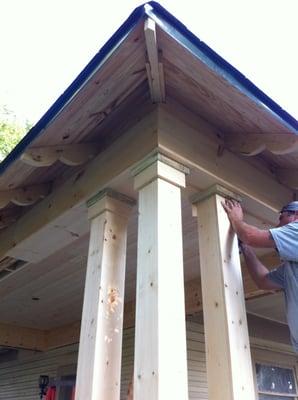 The porch has 15 wooden columns and ornately carved roof eaves restored as original.