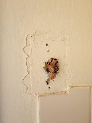 Unrepaired area of wall painted over