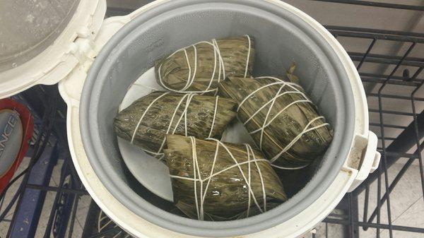 "Chinese tamales" warm in the rice maker in front of the cash register.