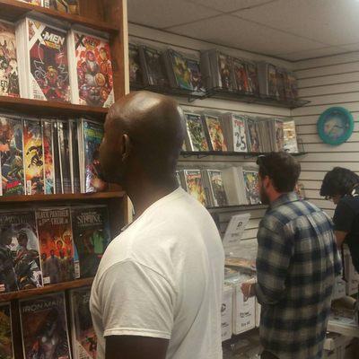 New customers and old checking out different comic racks.