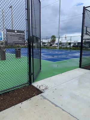 Two basketball courts fenced around.