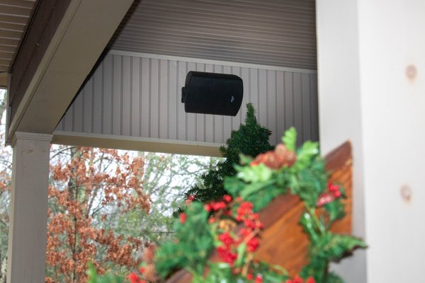 Outdoor rated speaker mounted on porch.