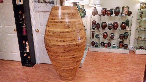 Beautiful wooden vessel, completely hand crafted.  Dolls to the left, vases to the right.