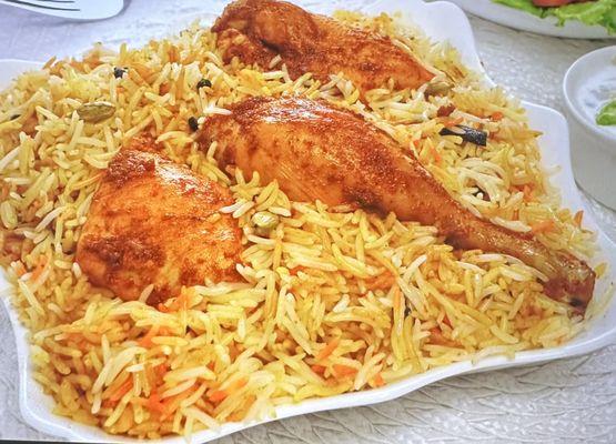 Chicken biryani with mixed rice and sauce