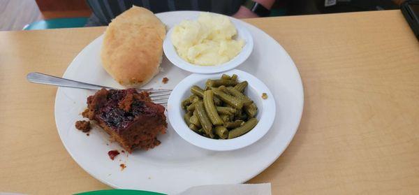 Meatloaf with a side of mashed potatoes, green beans and a roll