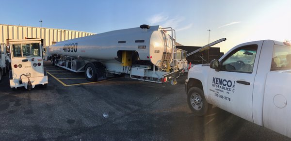 repairing hydraulic system on a fuel truck at the airport.