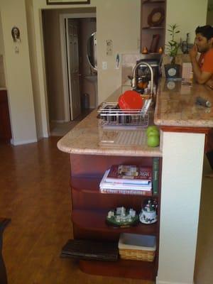 Kitchen granite countertop installation accomodating corner shelve.