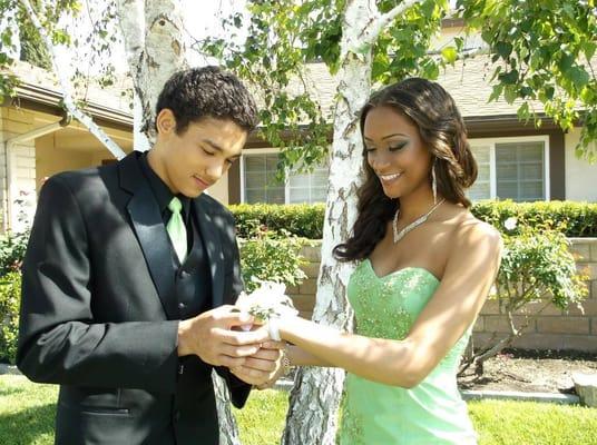 Adam presenting Megan with her corsage