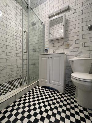 Completely renovated full bathroom with tiles throughout.