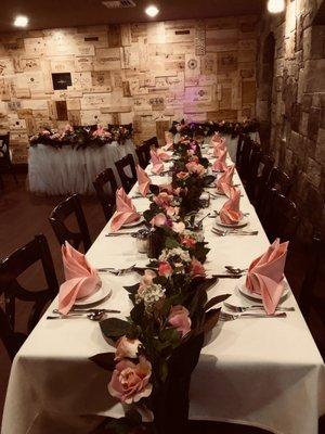 Another pretty in pink venue! But this one features beautiful, dark-green foliage and wooden chairs that just make you feel so cozy.