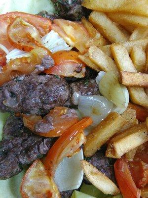 Grilled Seasoned Kobab sided with Grilled Tomatoes, Onion & French Fries. Come try it!