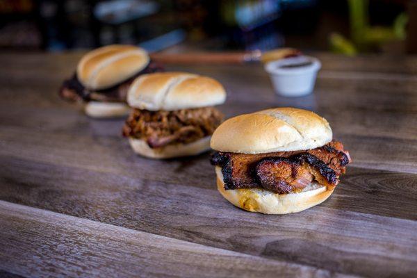 Freshly slow-smoked pulled pork, smoked brisket, pulled chicken on a bun --- #foodgoals.