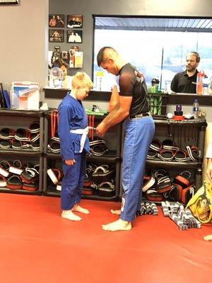 Coach James promoting one of our kids in Jiu-Jitsu Class.