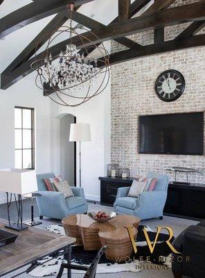 Soothing grays and blues ground this soaring space, with our custom designed light fixture adding a dramatic focal point.