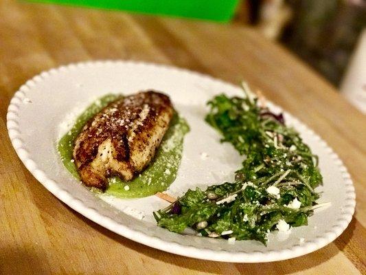 Pan seared lemon pepper tilapia on a pea purée, with a kale salad topped with champagne vinaigrette and feta cheese.