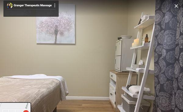 One of our single rooms for massage with shelf for clean towels, oils, etc.