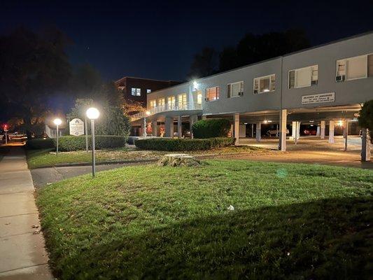 Sidewalk view of facility at night