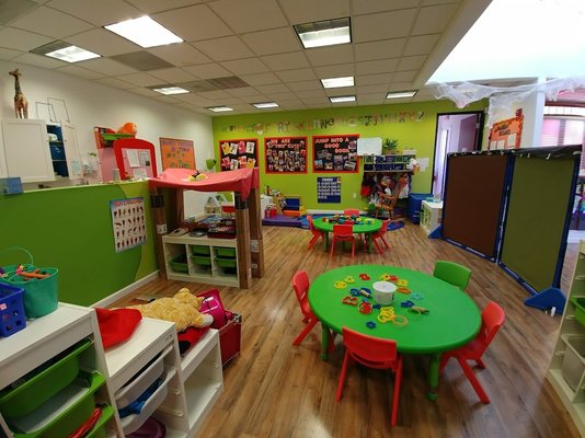 Our Two's room serves ages 2 to 3 (or until potty-trained) with a focus on self-help and regulation, potty-training, and social-emotional.