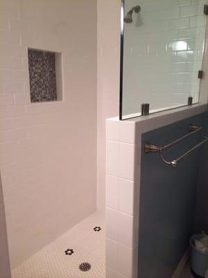 Repaired subway tile and matching glass mosaic insert in master bath