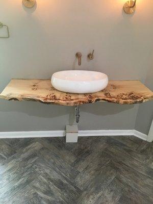 Custom sink on driftwood in remodeled basement full bath