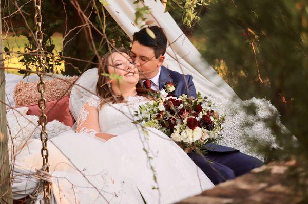 Bride and groom in the swing.