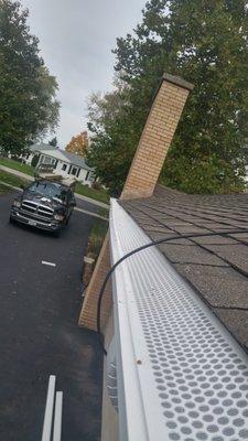 gutter guards .mesh filter goes under shingles .locks into gutter handle snow in winter.10 yr. warrantee.