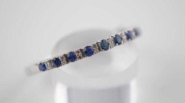 18K white gold bracelet encrusted with sapphires and diamonds.