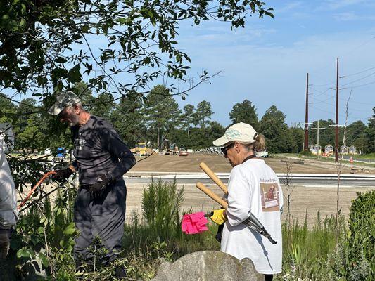 Members of the Independence Community helping to clean up the Lingo Harmon Cemetery next to the shop