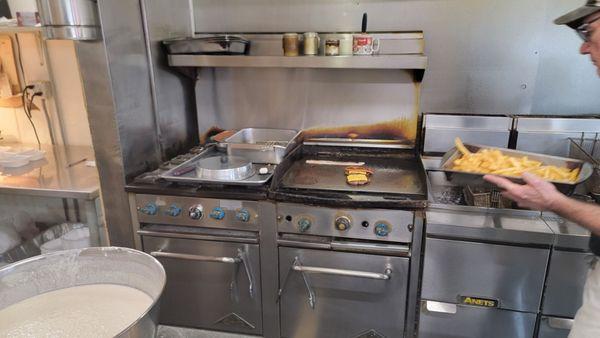 Burgers on the grill and fries out of the fryer